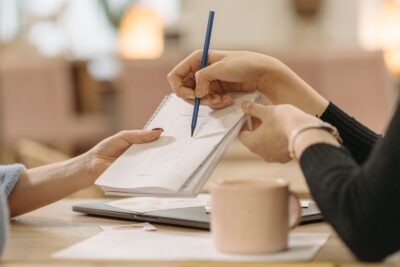 Member portal access. Emerging leader writing on paper during Executive Coaching